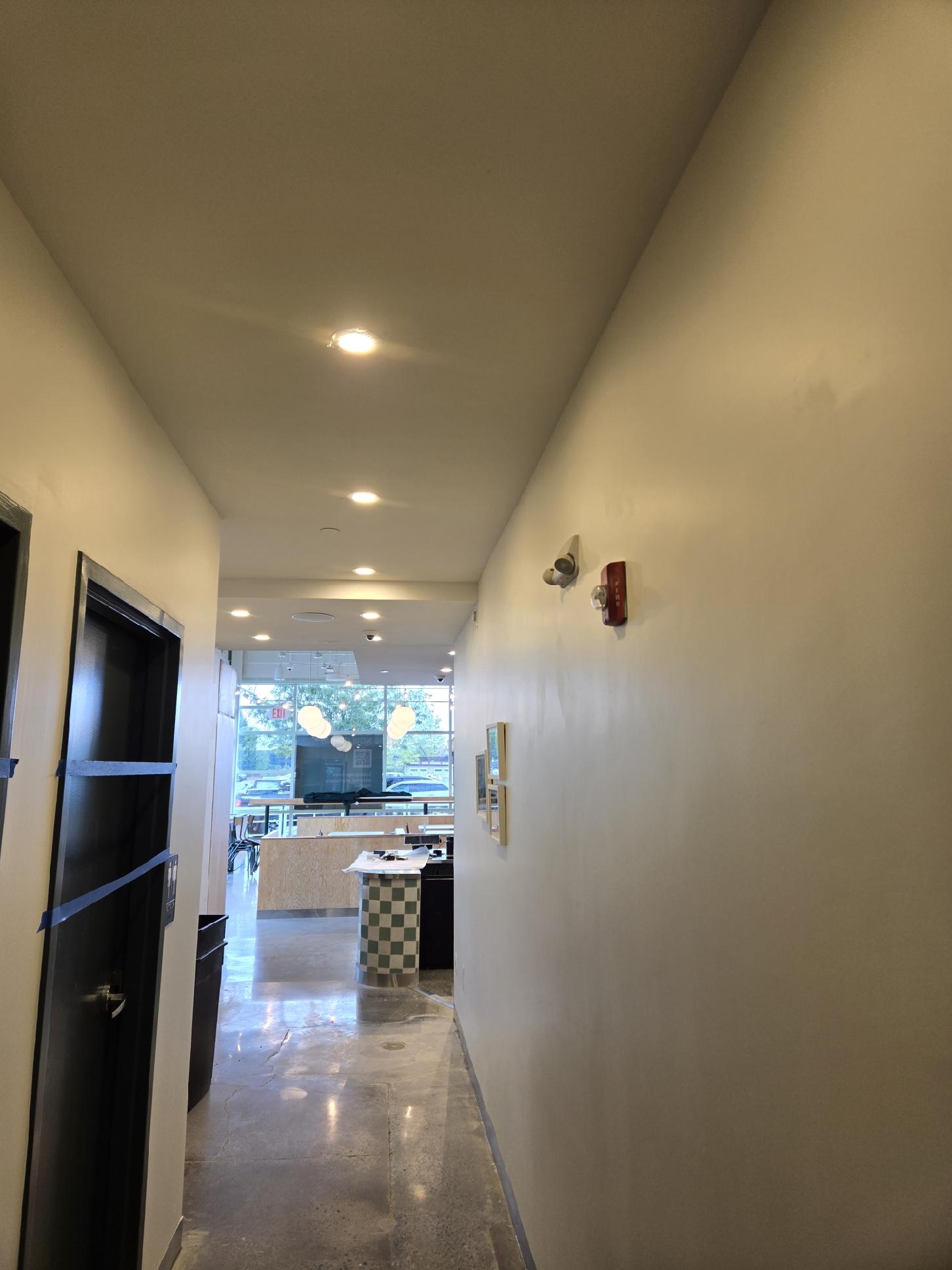 Commercial hallway with recessed lighting and fire alarm installation